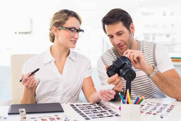 Photo editors looking at camera in their office