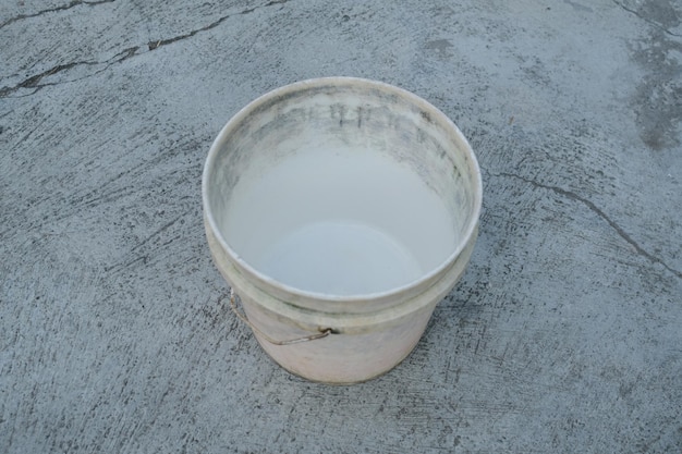 Photo of an empty white bucket on the ground