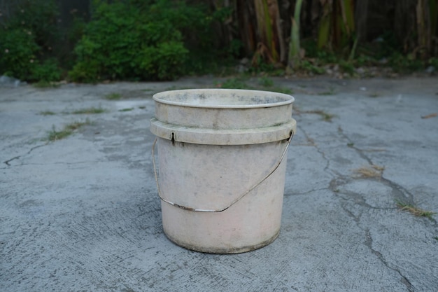 Photo of an empty white bucket on the ground