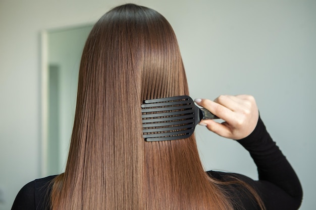 photo of a European girl with long and beautiful brunette hair at the beauty salon Shiny hair