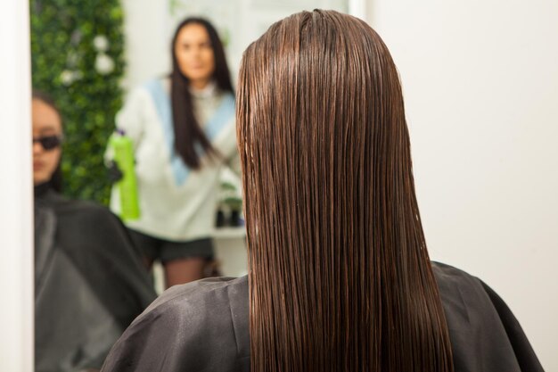 photo of a European girl with long and beautiful brunette hair at the beauty salon