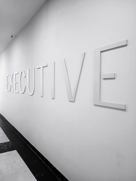 A photo of an Executive sign displayed on a wall in a mall