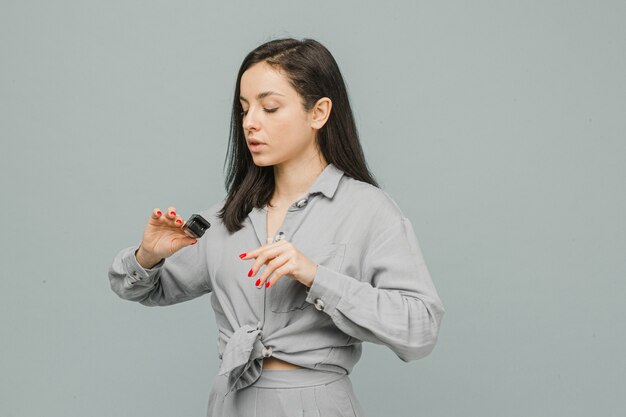 Photo female with pulse oximeter on her finger, checks her health