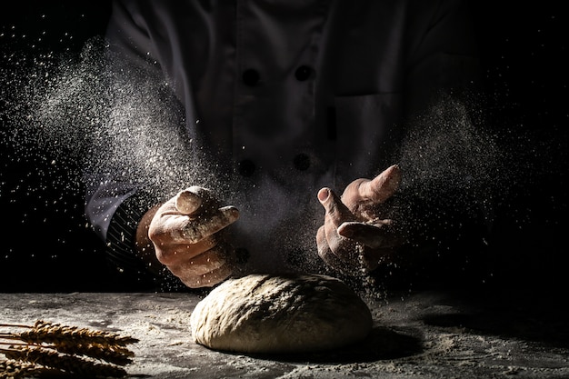 Photo of flour and men hands with flour splash