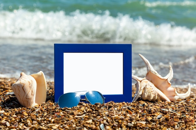 Photo photo frame on the beach, photography on the beach, sea shells, beach vacation, beach pebbles, picture, frame, beach, photo, sunglasses, reflection, background, sand, black sea, summer