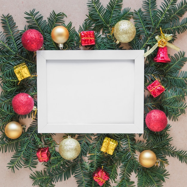 Photo frame on fir twigs with Christmas balls 