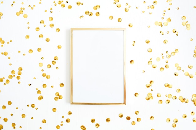 Photo frame mock up and golden confetti tinsel on white