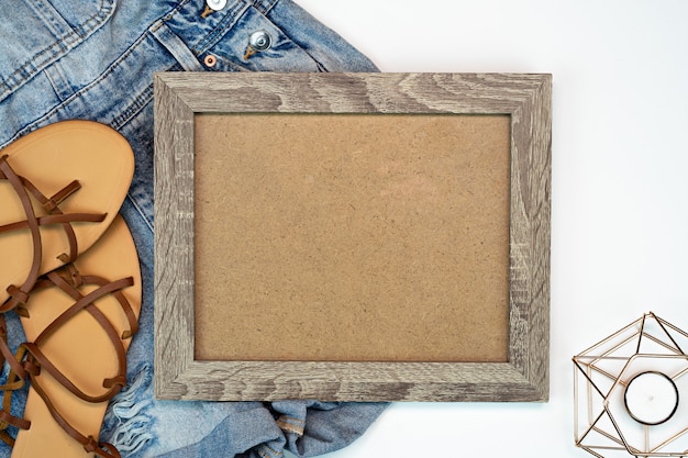 Photo frame mock up with jeans shorts and beach sandals