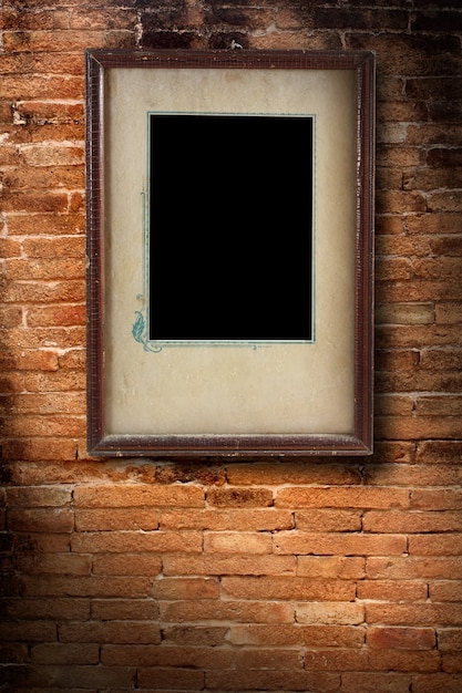 Photo photo frame on old brick wall texture