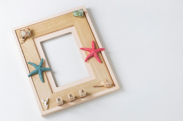 photo frame, starfish, seashells, the word sea. Background about summer vacation, memories