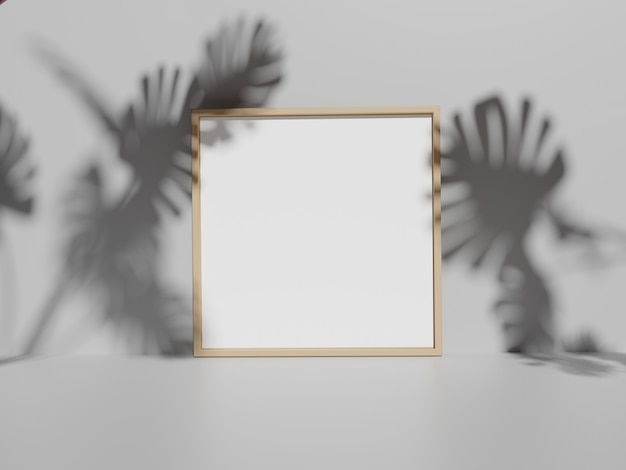 Photo frame on white wall with monstera leaves shadows