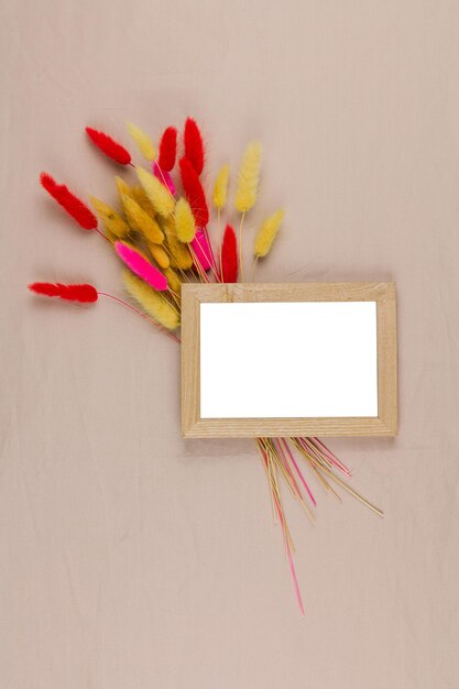 Photo frame with a decor of dried flowers on the background