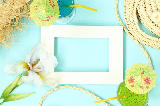 Photo frame with straw bag, flowers and cocktails