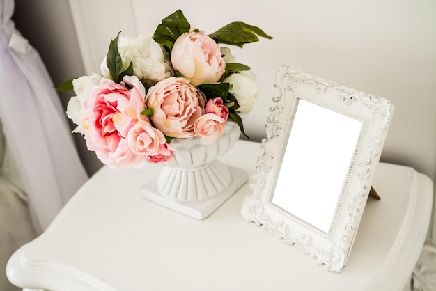 Photo frame with a white background in the interior of the bedroom