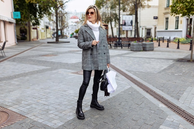 Photo of a free young woman blogger walking on a walking street