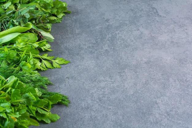 Photo of fresh healthy green leaves on stone background.