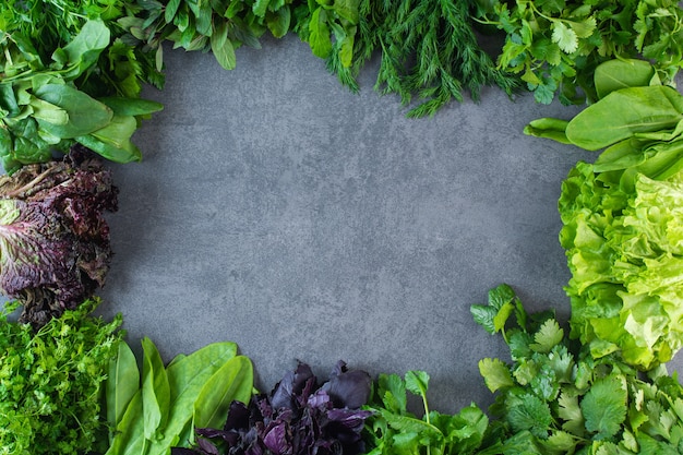 Photo of fresh healthy green vegetables on stone surface