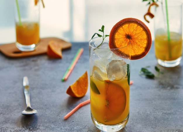 Photo of fresh orange juice in the glass jar. Summer healthy organic drink concept.