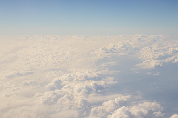 photo from airplane fluffy white beautiful clouds heaven window view.aircraft over the clouds