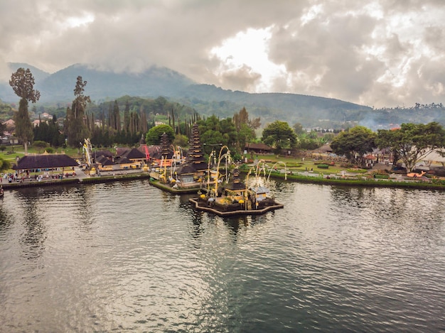 Photo from the drone Aerial view of Pura Ulun Danu Bratan Bali Hindu temple surrounded by flowers on Bratan lake Bali Major Shivaite water temple in Bali Indonesia Hindu temple