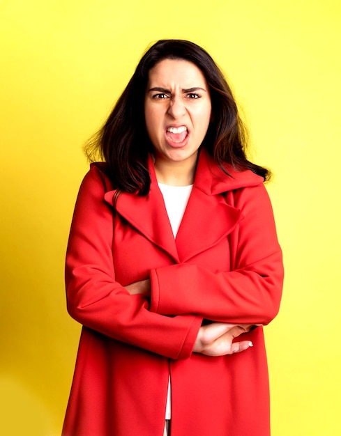 photo front view young female in red coat angry on yellow background