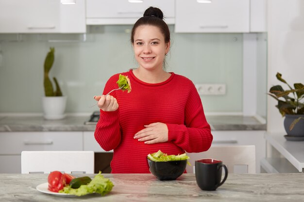 Photo of future mother eats healthy food