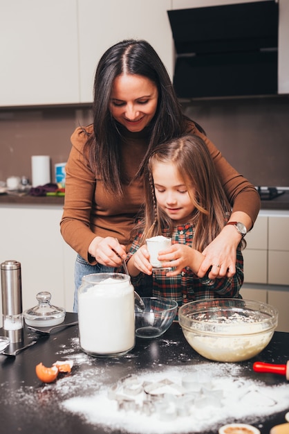 Photo of girl preparing some biscuits in kitchen