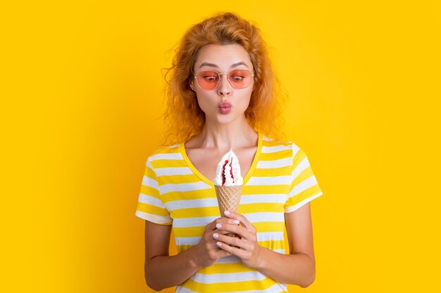 Photo of girl with cone icecream at summer girl with cone icecream isolated on yellow girl with cone icecream in studio girl with cone icecream on background