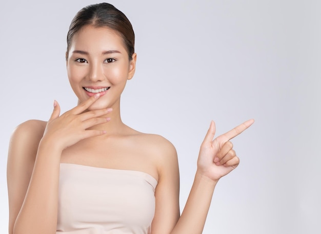 Photo of a gorgeous woman in a concept of empty space for beauty care product