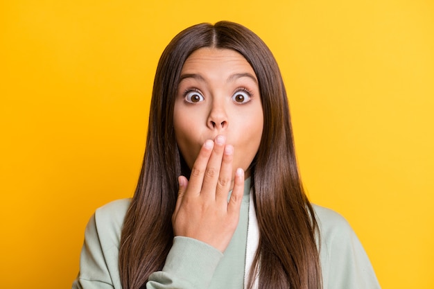 Photo of guilty tricky school girl wear casual grey outfit close mouth isolated yellow color background