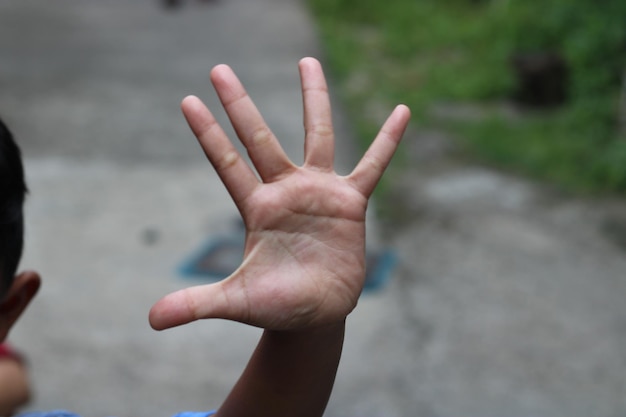 Photo of hand waving outside the street