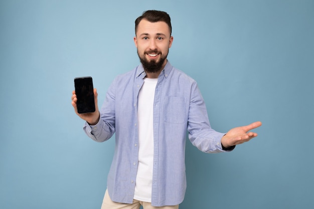 Photo of handsome good looking young brunette unshaven man with beard wearing casual white t-shirt