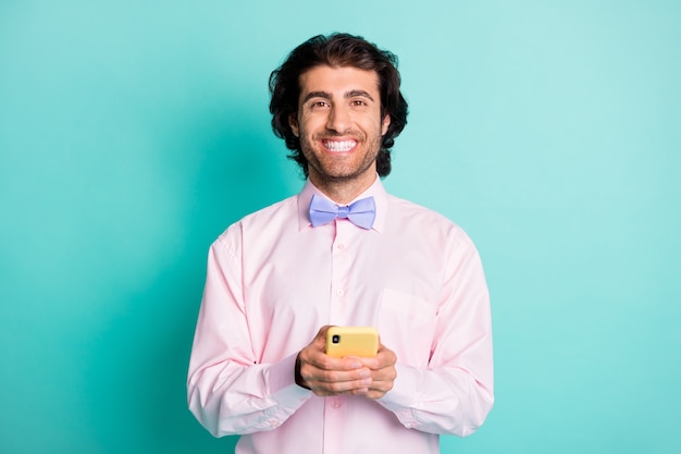 Photo of handsome toothy guy hold telephone wear shirt tie isolated on turquoise color background