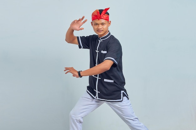 Photo of handsome young sportsman  dressed in kimono practice in karate