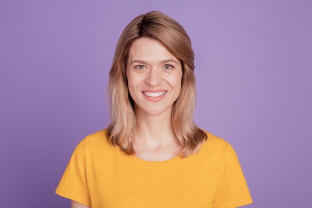 Photo of happy charming cute young woman attractive happy positive toothy smile isolated on violet color background