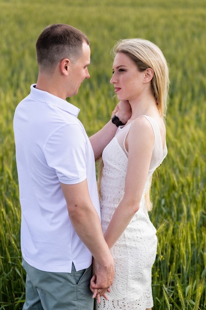 Photo of happy couple embracing in wheat field