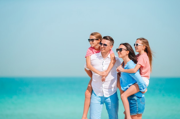 Photo of happy family having fun on the beach. Summer Lifestyle