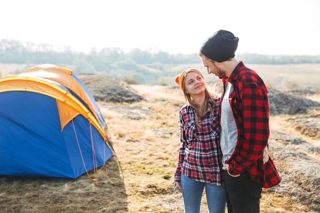 Photo of happy young loving couple outside in free alternative vacation camping over mountains.