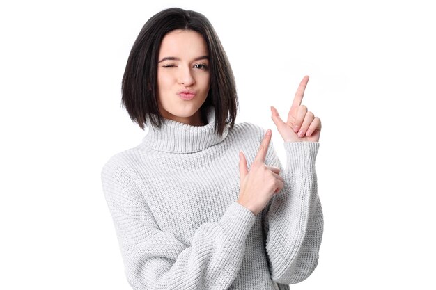 Photo of happy young woman standing isolated over white wall background Looking camera