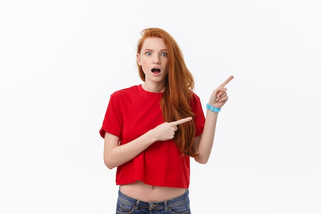 Photo of happy young woman standing isolated over white wall background.