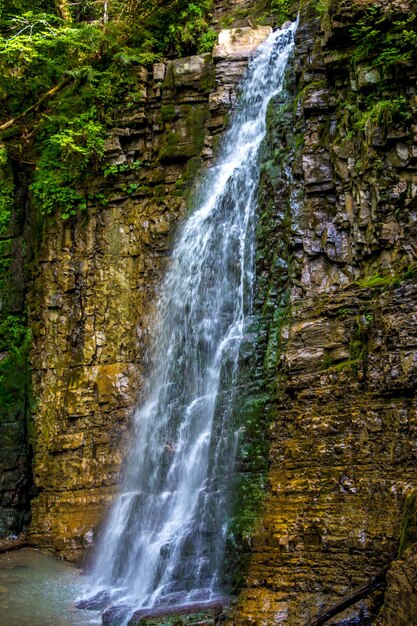 Photo of high beautiful waterfall in carpathian mountains