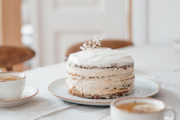 Photo of homemade white cake on the table in the living room