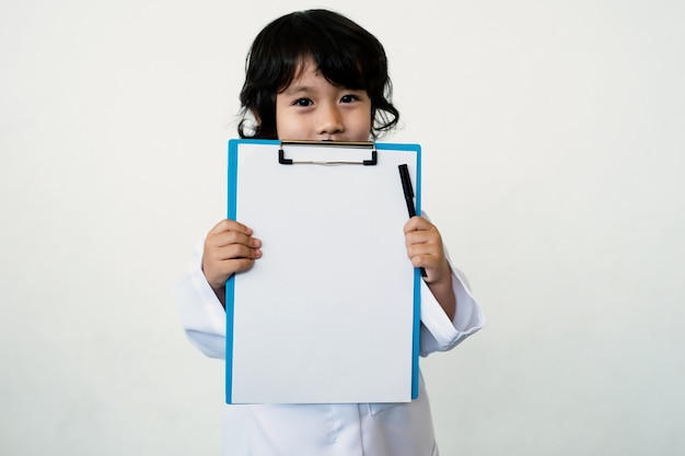 Photo of kid doctor with clipboard on white background.