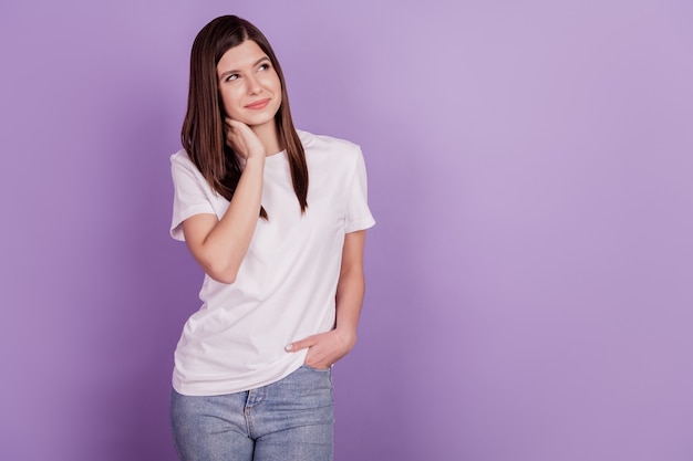 Photo of lady looking empty space think finger chin isolated purple background