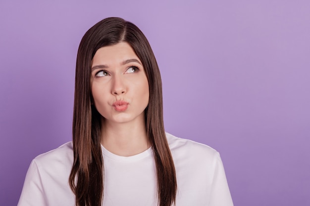 Photo of lady looking up empty space thinking isolated on violet background