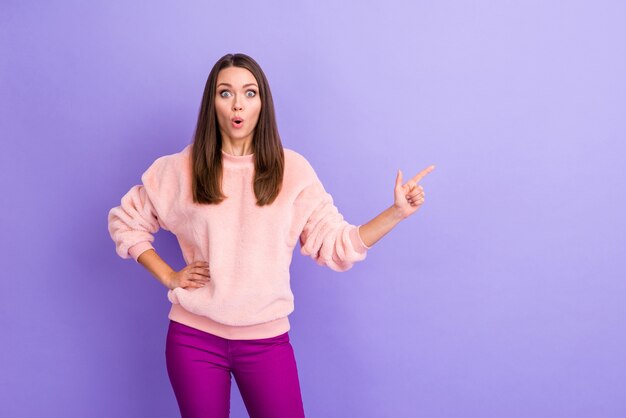 Photo of lady open mouth indicating finger empty space on purple background