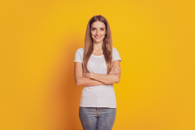 Photo of lady with arms crossed isolated yellow background