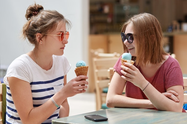 Photo of lovely young female models wears sunglasses