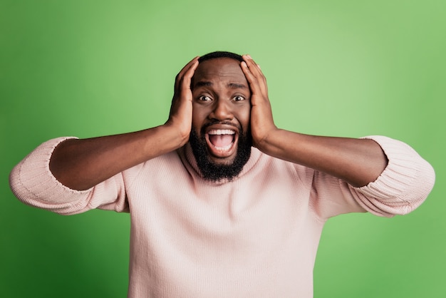 Photo of mad furious irritated guy close ears shout wear white shirt over green background