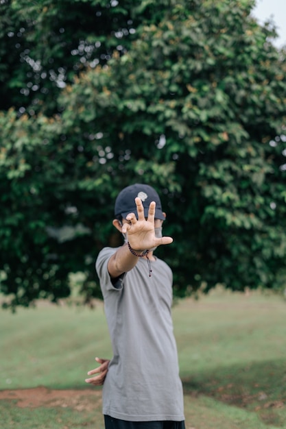 photo of a man covering face with his hands